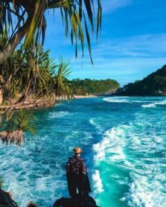 Berfoto dengan latar belakang keindahan pantai