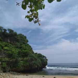 Foto di tepi pantai dengan formasi karang yang khas