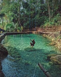 Area kolam alami dengan ayunan di atasnya